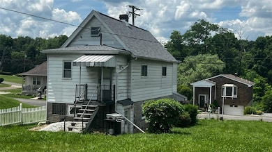 The back of the  home with a charming stoop.
