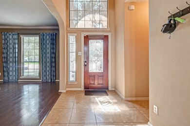 Leaded glass and wood front door to double height entry with 18