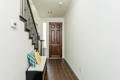 Inviting entry with tile flooring and iron ballast
