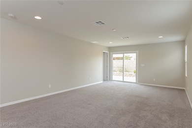 Empty room featuring carpet, baseboards, recessed
