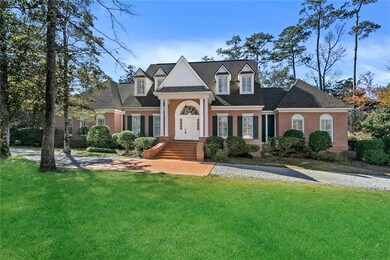 Beautiful brick home with gas lanterns set amid 1.
