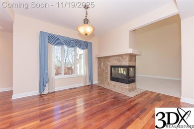 featuring a tiled fireplace and hardwood / wood-style flooring