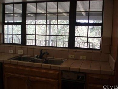Kitchen window looks to covered deck.