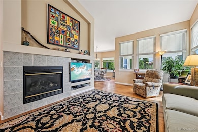 Living room with gas fireplace and windows facing east to the backyard.