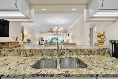 Gorgeous renovated kitchen w/ special pantry door, SS appliances (counter depth fridge/slide-in range), granite counters, crown molding, tumbled marble backsplash, under counter lighting & engineered wood floors!