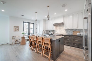 Kitchen featuring white cabinetry, light hardwood 