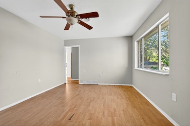 Spare room featuring light wood-type flooring and a ceiling fan