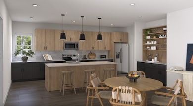 Kitchen with a kitchen island with sink, stainless steel appliances, pendant lighting, modern cabinets, and recessed lighting