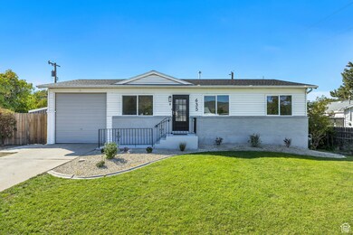 Single story home with driveway, brick siding, and a garage