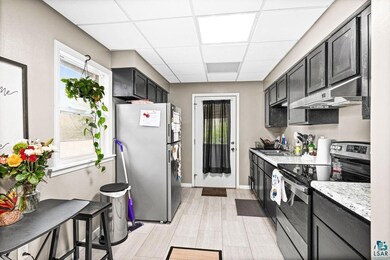 Kitchen with light stone counters, appliances with