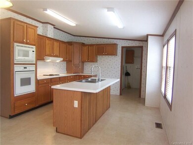 Kitchen is large and has an island.