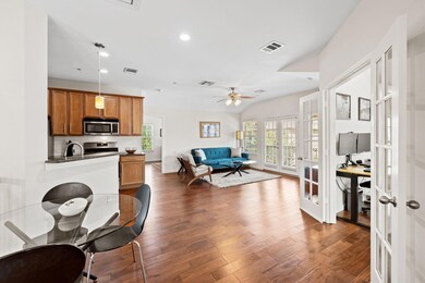 Living room featuring french doors, a ceiling fan
