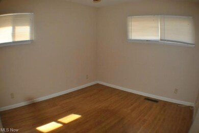 Bedroom 1 with hardwood floors.