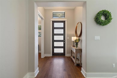 Entryway featuring dark wood-style flooring and o