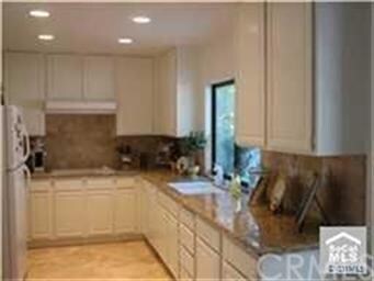 Granite kitchen counters with window overlooking  