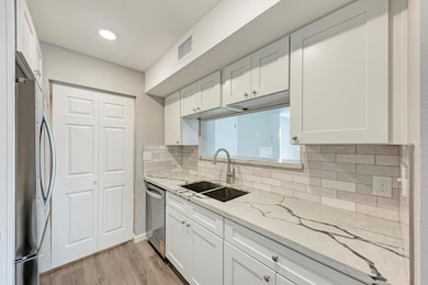 Kitchen with a sink, stainless steel appliances, 
