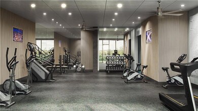 Gym featuring ceiling fan and a drop ceiling