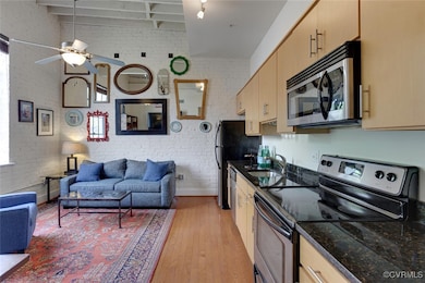 Kitchen featuring open floor plan, hardwood floors