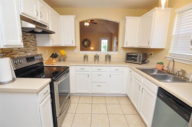 The kitchen comes with tons of cabinet space, tile