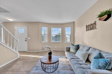 Living area with tile patterned floors and baseboa