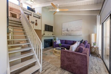 LIVING ROOM WITH STAIRS TO LOFT.