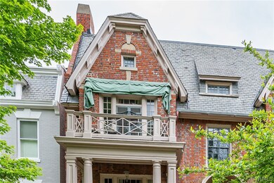 View of front of property with a balcony