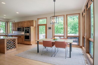 Window-wrapped dinette with backyard views.