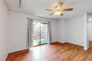 Living room featuring a textured ceiling, baseboar