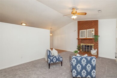 Living area with ceiling fan, carpet, vaulted ceil