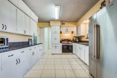 Kitchen with visible vents, light tile patterned f
