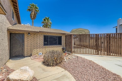 Entrance to property with a gate, brick siding, ro