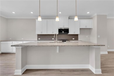 Kitchen with ornamental molding, a sink, stainless