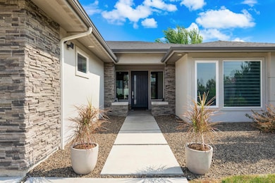 Property entrance featuring stucco siding and stone siding