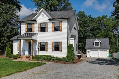 View of front of property featuring a detached gar