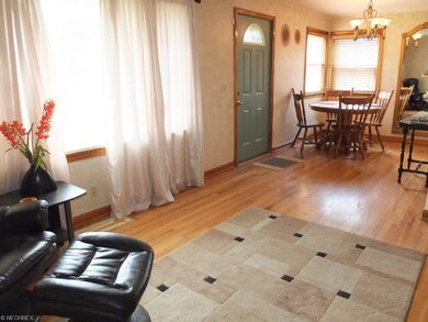 Living room with wood flooring and picture window.