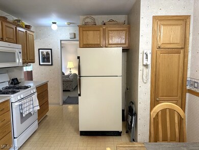 Kitchen featuring white appliances and oak cabinets