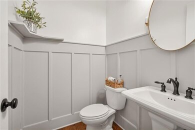 Crisp updates and thoughtful details give this guest half bath a polished, welcoming feel.