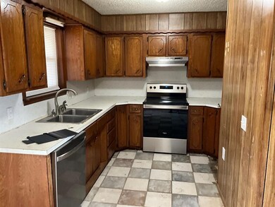 Kitchen featuring light tile flooring, stainless s