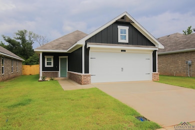 Craftsman-style house featuring brick siding, board and batten siding, roof with shingles, and concrete driveway