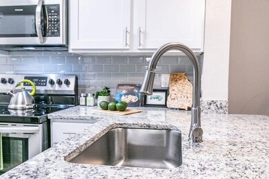 Kitchen with tasteful backsplash, stainless steel 