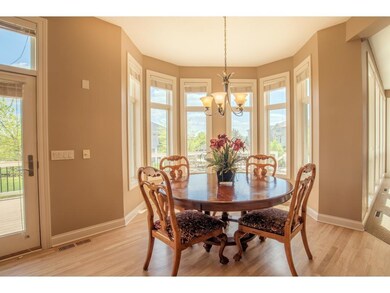 Window-wrapped dinette with backyard views and eas