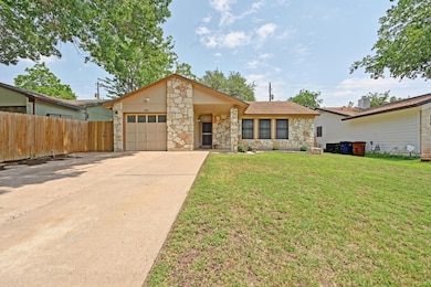 View of front of house featuring stone siding, a 