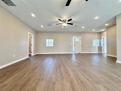 Unfurnished living room featuring hardwood / wood-
