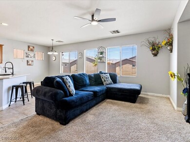 Living room featuring ceiling fan, baseboards, and