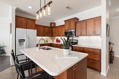 Kitchen featuring sink, crown molding, a kitchen b