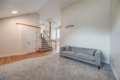 Living room/ Formal Dining Room featuring high vaulted ceiling and light carpet
