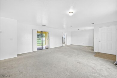 Unfurnished room featuring tan carpet
