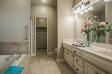 Master bathroom has ceramic tile floor, double van