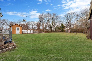 View of yard featuring a fenced backyard, a storag
