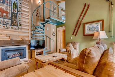 Living area with a towering ceiling, stairs, and a